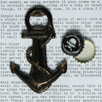 Image of a cast iron anchor bottle opener next to a bottle cap.