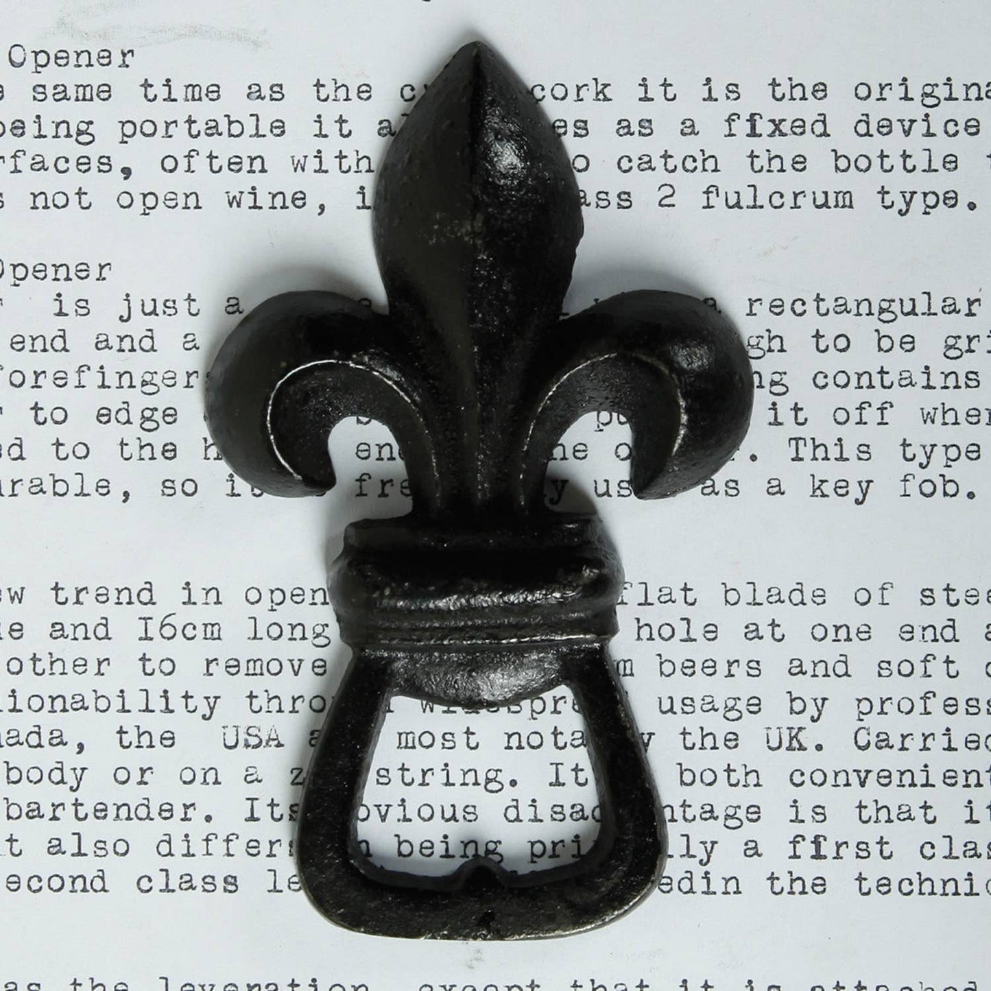 Image of a cast iron fleur de lis bottle opener.
