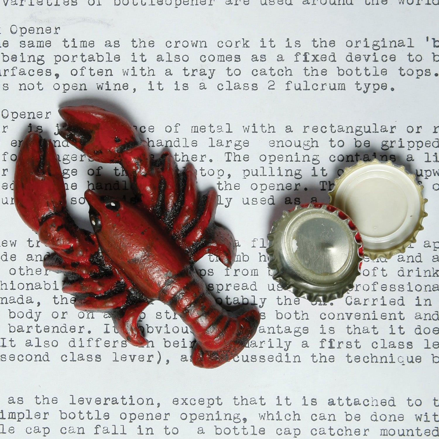 Image of a red cast iron bottle opener next to a bottle cap.
